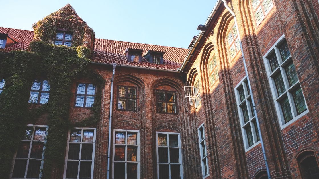 Historic brick building with traditional windows showing the evolution of window design